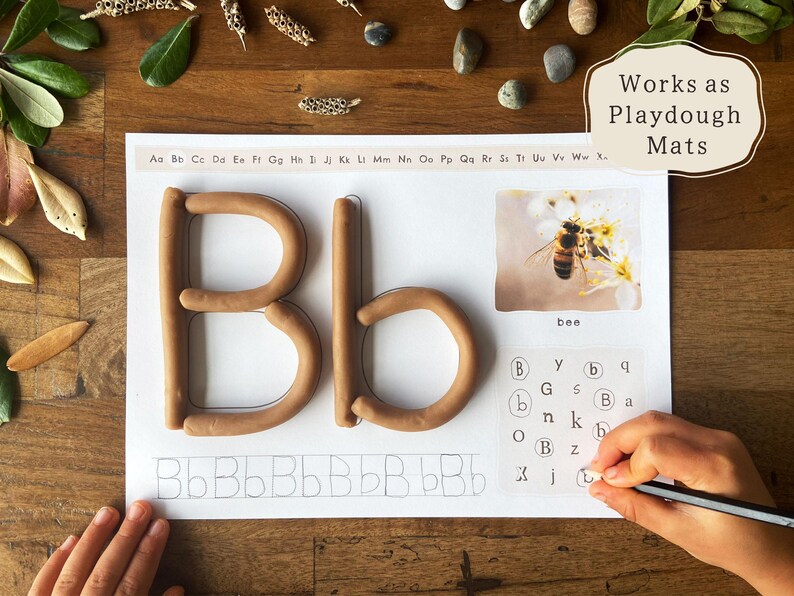 May include: A learning activity mat with the letter "Bb" formed from brown playdough. The mat includes a picture of a bee, the word "bee", and letter tracing exercises. The text "Works as Playdough Mats" is also visible.