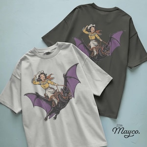 cowgirl riding bat png digital download, western halloween cowgirl design, giant black bat with purple wings, vintage rodeo girl sublimation png, smiling cowgirl flying on bat, spooky western rider graphic, halloween cowgirl shirt design, cowboy hat and fringed shirt illustration, saddle and reins bat rider, orange scarf western girl png, country halloween cowgirl clipart, bat lover spooky season design, transparent background png, instant download western halloween file, halloween rider graphic