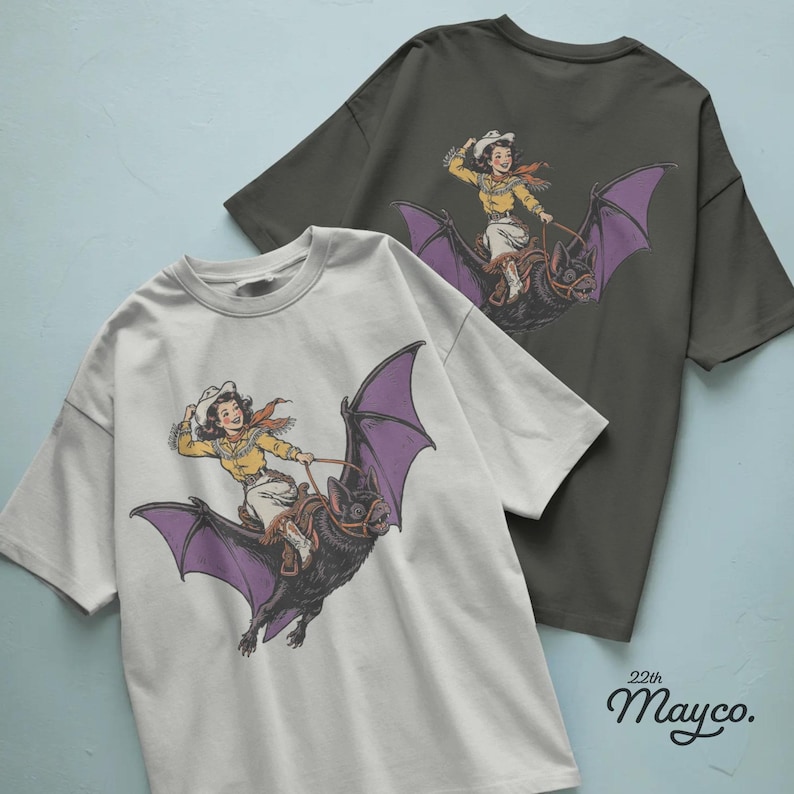 cowgirl riding bat png digital download, western halloween cowgirl design, giant black bat with purple wings, vintage rodeo girl sublimation png, smiling cowgirl flying on bat, spooky western rider graphic, halloween cowgirl shirt design, cowboy hat and fringed shirt illustration, saddle and reins bat rider, orange scarf western girl png, country halloween cowgirl clipart, bat lover spooky season design, transparent background png, instant download western halloween file, halloween rider graphic