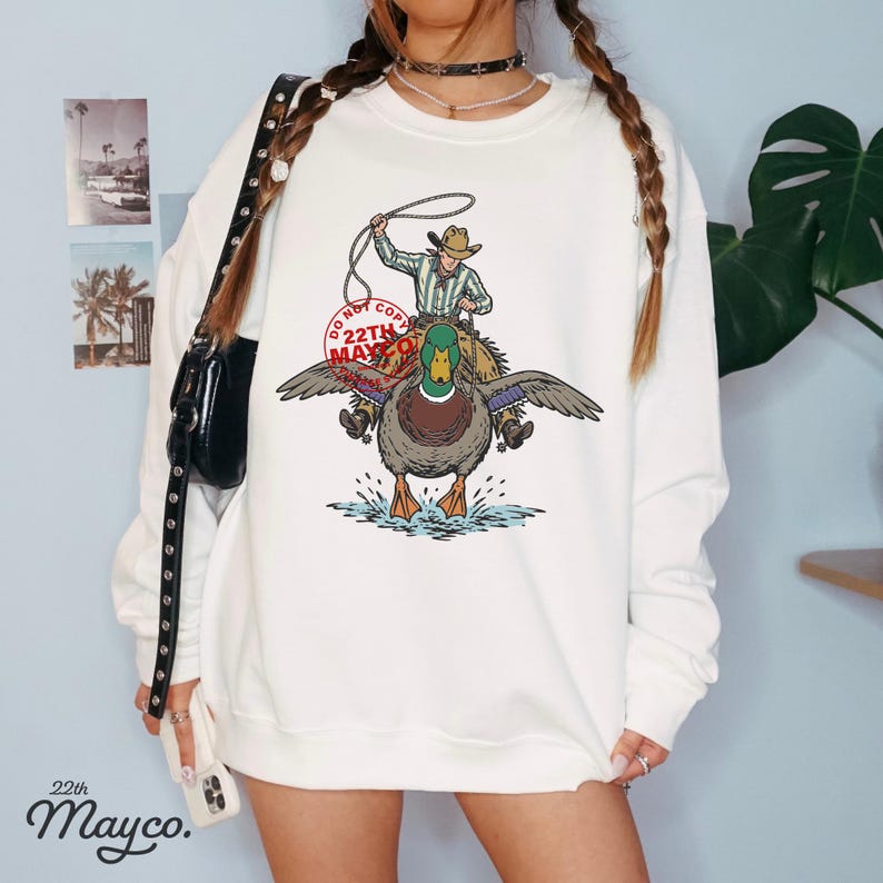 2026 western trend duck png, american heritage duck graphic, lake life aesthetic art, western theme park souvenir art, waterfowl lifestyle illustration, country bash party favor design, ranch tour promotional graphic, duck lover merchandise art, kids western duck shirt, cute but rugged duck design, western heritage artwork for apparel, southern summer camp graphic, duck mascot for brand hunting club logo, modern western aesthetic gorpcore western duck graphic design asset file viral animal humor