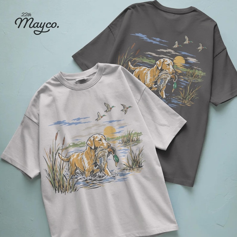 duck dog png, duck retrieving dog design, retriever hunting shirt, hunting dog with duck png, waterfowl dog sublimation, bird dog clipart, gundog shirt graphic, dog carrying mallard png, working retriever design, loyal hunting dog artwork, duck hunter dog png, marsh retriever shirt, outdoor dog hunting design