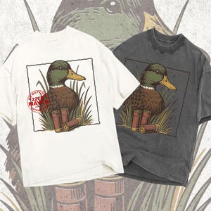 mallard drake head png, shotgun ammo clipart, hunting cartridge art, water fowl hunting, vintage gun hunting, duck calling graphic, hunting lodge art, man cave sublimation, rustic cabin decor, vintage woodcut duck, linocut animal art, distressed hunting design, retro ammo shirt, hunting camp png, wild game hunting art, trophy duck portrait, hunter lover gift, outdoor adventure, marsh hunting graphic