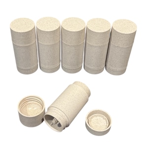 May include: A collection of beige cylindrical containers with matching lids. One container is disassembled, revealing its internal components. The containers have a speckled texture and a minimalist design, suitable for various storage purposes.