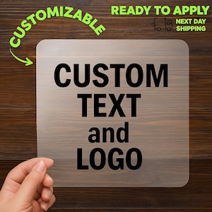 May include: A square, transparent sign with rounded corners, featuring the words "CUSTOM TEXT and LOGO" in bold black letters. The sign is set against a wood grain background. The words "CUSTOMIZABLE" and "READY TO APPLY" are also visible.