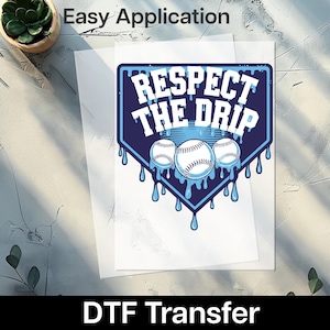 May include: A white DTF transfer sheet with a baseball-themed design. The design features the text "RESPECT THE DRIP" in white, with three baseballs and blue dripping accents. The words "Easy Application" and "DTF Transfer" are also visible.