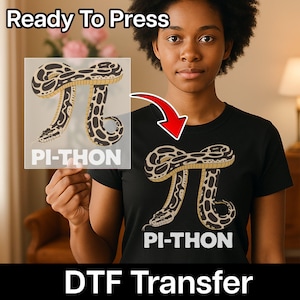 May include: Black t-shirt featuring a graphic of a snake in the shape of the mathematical symbol pi, with the text "PI-THON" below. The words "Ready To Press" and "DTF Transfer" are also visible.