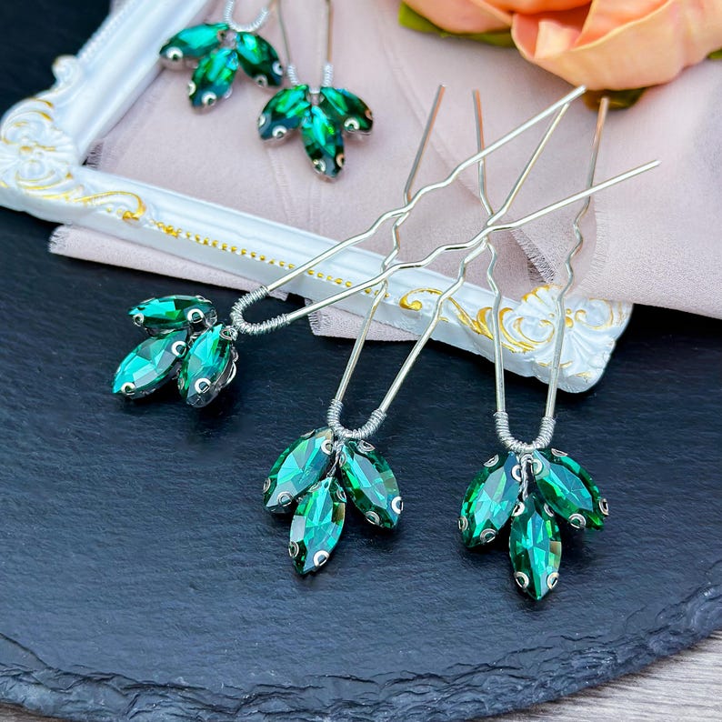 Elegant green crystal hair pin in silver, featuring sparkling deep green crystals set in a sleek silver alloy frame, perfect for adding a touch of natural beauty to bridal or formal hairstyles.
