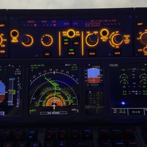 May include: A detailed view of an aircraft cockpit panel with multiple illuminated displays and controls. The displays show various flight data, including altitude, speed, and engine performance. The panel is dark with orange and blue lighting.