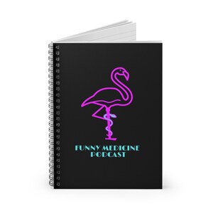 May include: A black spiral notebook with a pink flamingo illustration and the text "FUNNY MEDICINE PODCAST" in blue.