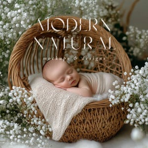 May include: A sleeping baby swaddled in a cream-colored wrap rests in a woven wicker basket. The basket is surrounded by white flowers. The image has the text "MODERN NATURAL mockups & designs" in a stylized font.