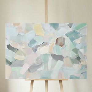 May include: Abstract painting on canvas with a textured, layered style. The painting features a variety of muted colors, including light blue, green, gray, and beige. The colors are blended together to create a soft, dreamy effect.