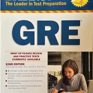 May include: A book cover for the GRE test preparation guide by Barron's. The cover is white, blue, and yellow, with the title "GRE" in large blue letters. The book includes practice tests and review materials. A student is studying.