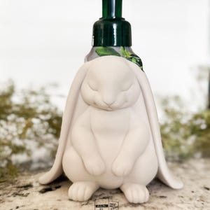 May include: A set of three ceramic mugs with a speckled, matte finish. The mugs are in shades of cream, light gray, and dark gray. Each mug has a simple, modern design and a rounded handle.