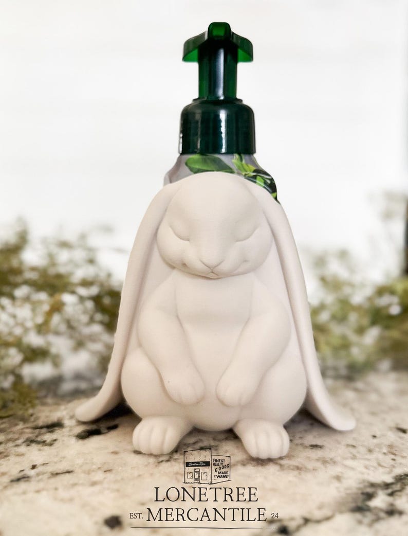 May include: A set of three ceramic mugs with a speckled, matte finish in cream, light grey, and dark grey. Each mug has a simple, modern design and a rounded handle.