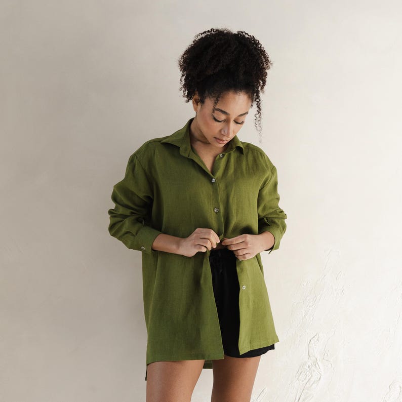 May include: A long-sleeved, olive green linen shirt with a button-up front and a relaxed fit.