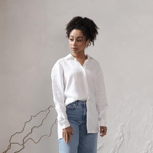 May include: A white linen shirt with long sleeves and a button-down collar. The shirt is slightly oversized and has a relaxed fit.