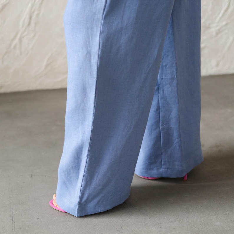 May include: A pair of wide-leg pants in a light blue color. The pants are made of a soft, flowing fabric and have a relaxed fit.