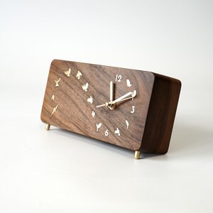 Sturdy brass feet provide optimal viewing angle for the solid walnut desk clock – a perfect blend of elegance and functionality.