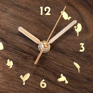Close-up of the brass bird motif embedded in solid walnut wood – a unique and artistic design for modern home or office decor.