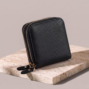 Classic midnight black pebble leather jewelry travel case, showcasing the minimalist design and premium weighted feel.