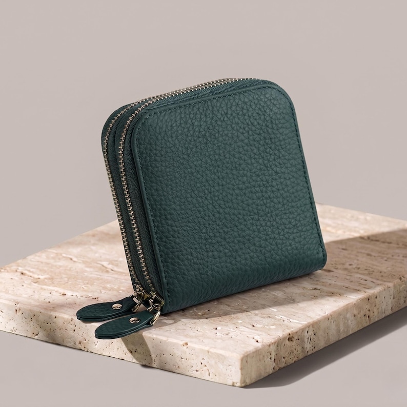 Forest green genuine leather jewelry pouch with a sophisticated pebble finish and durable double-zipper design.