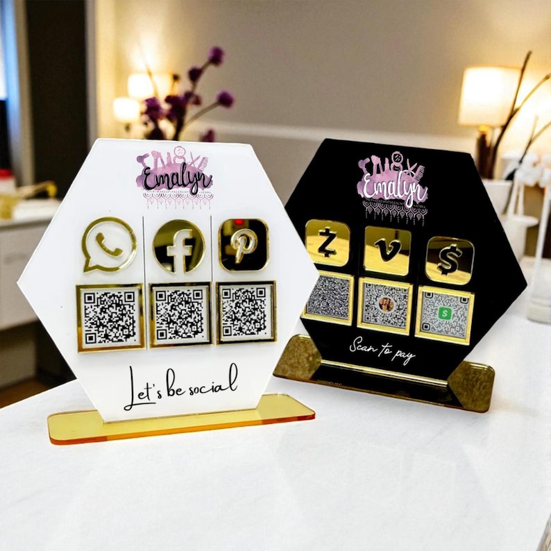 May include: Two hexagonal social media displays, one white and one black, with gold-coloured icons and QR codes. The white display has the text "Let's be social." The black display has the text "Scan to pay."