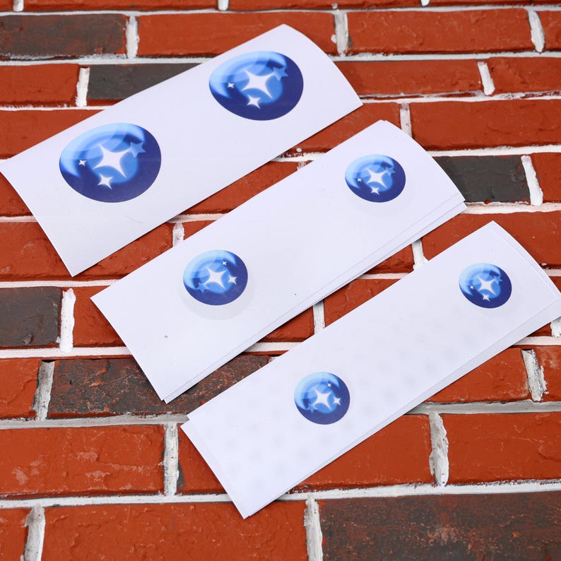 May include: Four white sheets of paper with blue star stickers on them. The stickers are different sizes and are arranged in a decreasing size order.