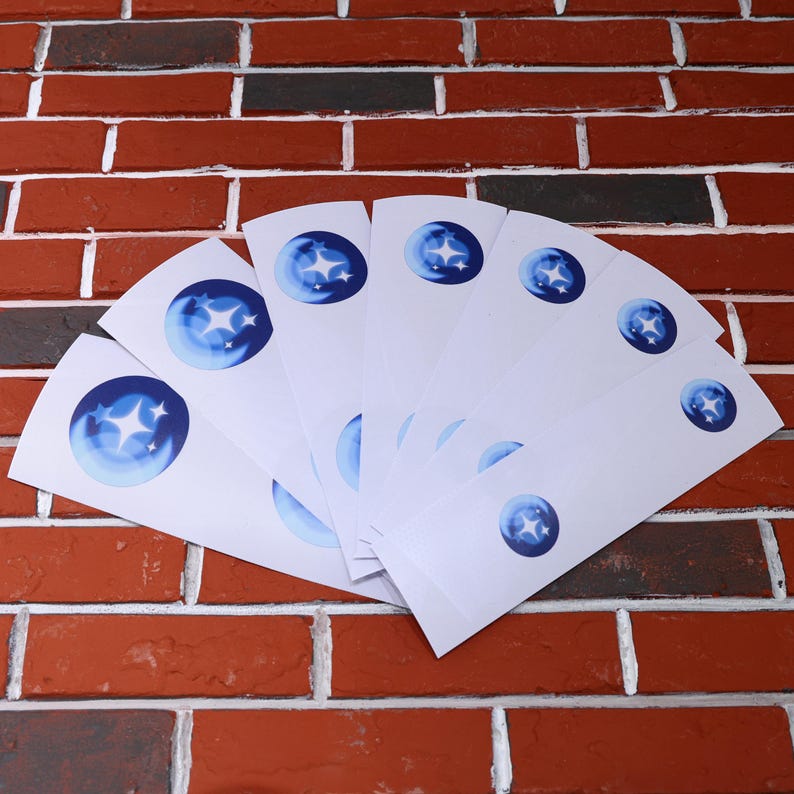 May include: A set of ten white bookmark cards with a blue and white star design. The bookmarks are arranged in a fan shape.
