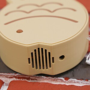 Taiyaki Fish Shaped Portable Fan held by a hand, illustrating its perfect fit for easy portability and usage. The fan’s fun and cute Japanese street snack-inspired design makes it a must-have for anime and kawaii fans, and the 3D printed PLA construction ensures it’s sturdy and environmentally friendly. Whether you’re headed to a summer festival, gaming marathon, or vacation getaway, this USB rechargeable fan delivers a three-speed breeze to keep you comfortable and cool.