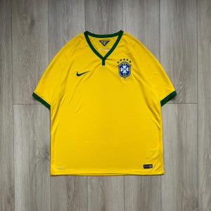 Pu&ograve; includere: Maglia da calcio gialla del Brasile con finiture verdi su colletto e maniche. La maglia presenta il logo Nike e l'emblema della Confederazione brasiliana di calcio. La maglia &egrave; realizzata in materiale leggero.