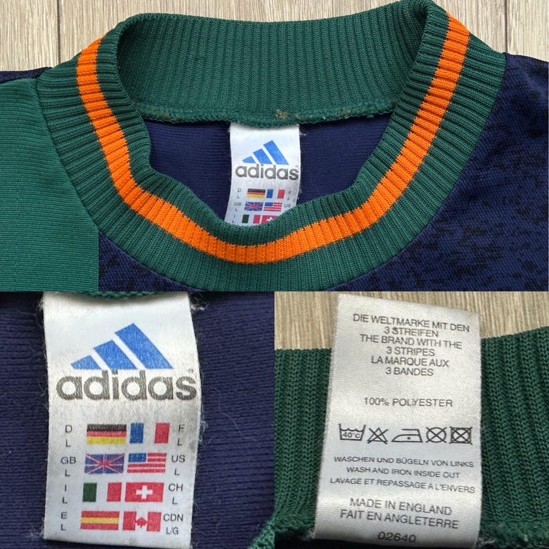 May include: Close-up of a vintage Adidas athletic jersey. The jersey features a navy blue, green, and orange color scheme. The Adidas logo is visible on the tag. The jersey is made of 100% polyester.