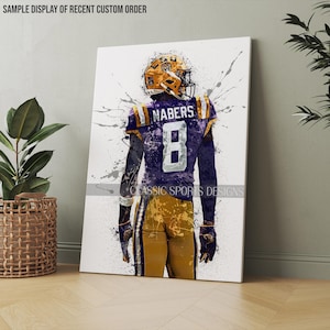 May include: A watercolor-style illustration of a football player wearing a purple and gold jersey with the number 8 and the name "NABERS" on the back. The player is facing away from the viewer and is standing on a white background with splattered paint.
