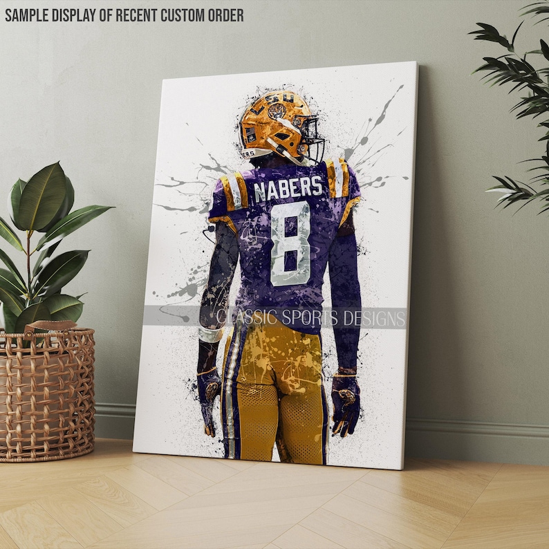 May include: A watercolor-style illustration of a football player wearing a purple and gold jersey with the number 8 and the name "NABERS" on the back. The player is facing away from the viewer and is standing on a white background with splattered paint.