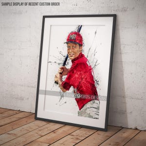 May include: A watercolor-style illustration of a baseball player in a red jersey with a white baseball cap. The player is holding a baseball bat and is surrounded by splashes of paint.