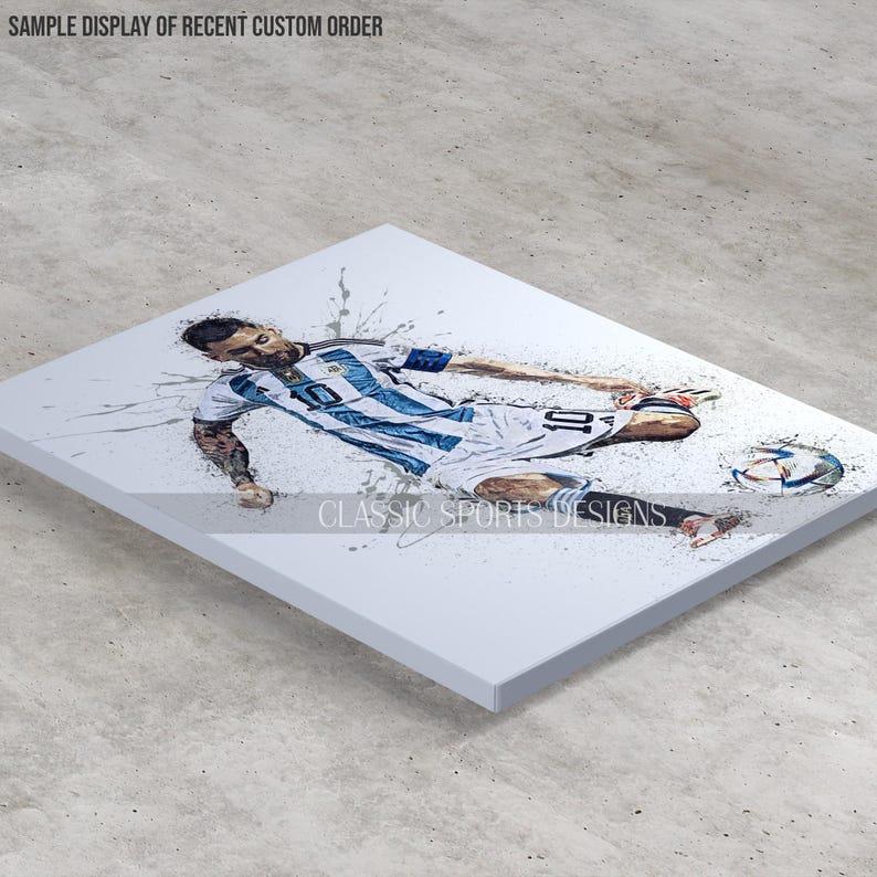 May include: A watercolor-style illustration of a soccer player in a blue and white striped jersey with the number 10 on the back. The player is dribbling the ball and is surrounded by white paint splatters.
