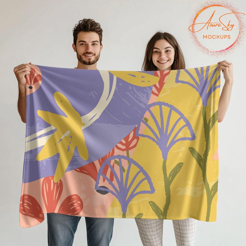 May include: Two people are holding up a large fabric tapestry with a colorful abstract floral pattern. The tapestry is made of a soft, flowing fabric and features a variety of colors, including yellow, purple, pink, and red.