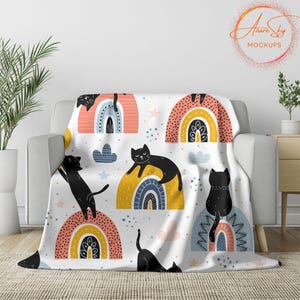May include: A white throw blanket with a repeating pattern of black cats and colorful rainbows. The blanket features a whimsical design with a modern aesthetic.