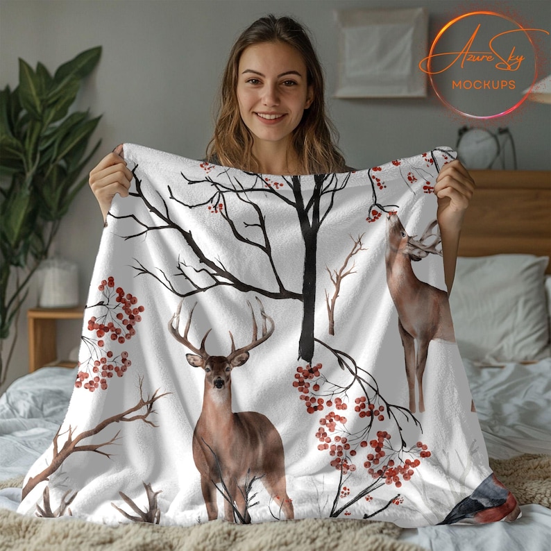 May include: White fleece blanket with a watercolor design of deer and red berries on bare branches.