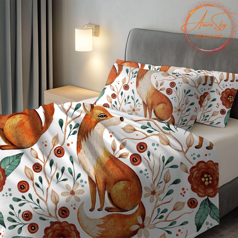 May include: A white bedding set with a repeating pattern of orange foxes, green leaves, and brown flowers. The bedding set includes a duvet cover and two pillowcases.