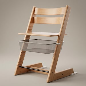 May include: A light-coloured wooden high chair with a grey metal basket and a footrest. The chair has a seat and backrest made of curved wooden slats. The chair is designed for a child.