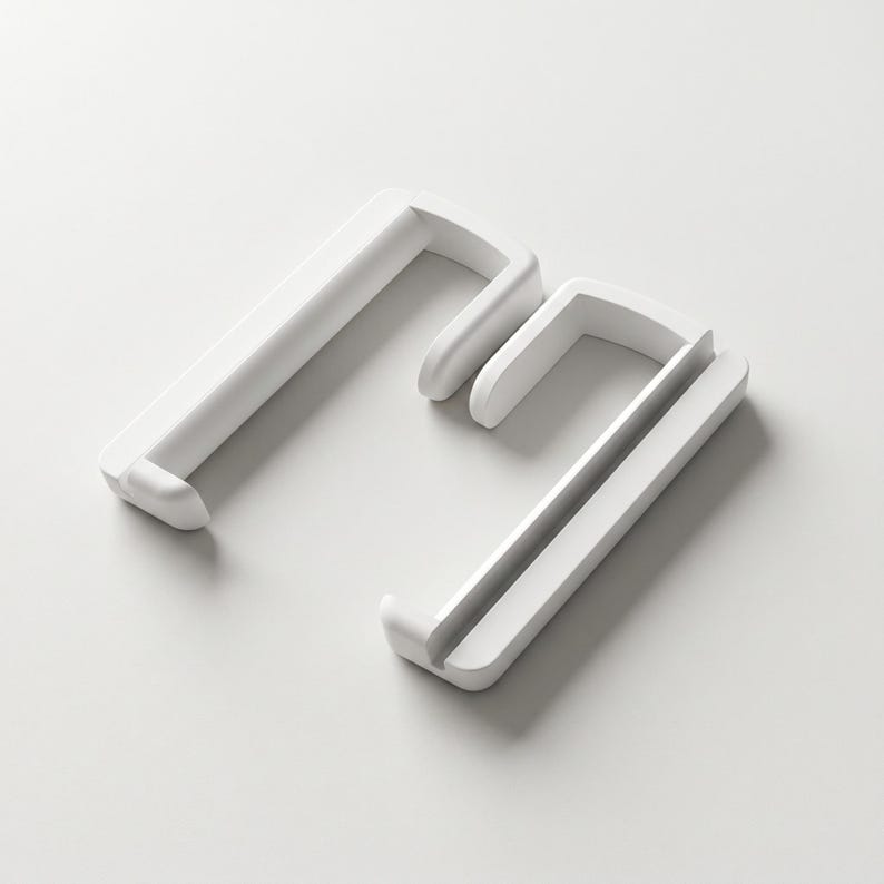 May include: Two white, L-shaped shelf brackets with a minimalist design. The brackets are made of a solid, smooth material and have a simple, modern aesthetic. The brackets are displayed on a white background.