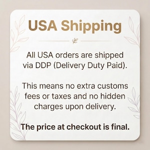 May include: A square, off-white card with rounded corners displays "USA Shipping" in gold. The card details shipping information, stating orders are shipped via DDP, with no extra fees or taxes, and the price at checkout is final.