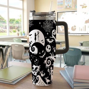 May include: A black and white stainless steel tumbler with a handle and a clear straw, featuring a repeating pattern of silhouettes including a moon, a couple, spiderwebs, bats, and various skeletal characters on a dark background.