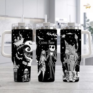 May include: Three black and white tumblers with handles and straws, featuring a repeating pattern of characters and scenes from The Nightmare Before Christmas. The center tumbler displays the text Custom Name above two central character figures.