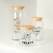 three glass jars with cat images on them