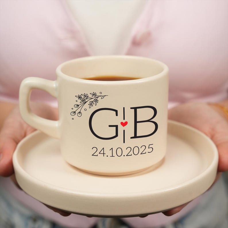 a person holding a cup of coffee on a plate