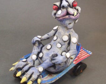 Ceramic Alien in Antique Rocket Wagon Mixed Media Sculpture