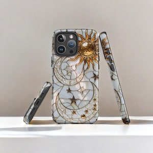 May include: A white iPhone case with a mosaic design featuring a gold sun, moon, and stars. The case is made of durable plastic and has a sleek, modern look.