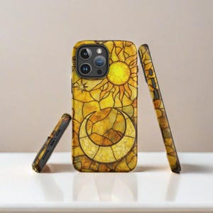 May include: A yellow and gold phone case with a stained glass design of a sun and moon. The case is shown from three different angles.