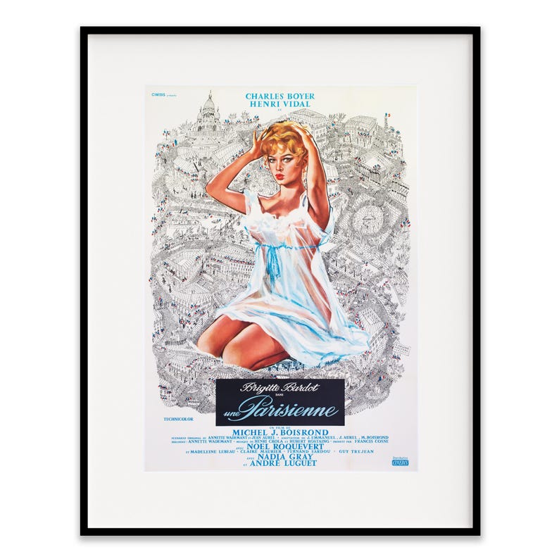May include: Framed vintage movie poster for "Une Parisienne" featuring Brigitte Bardot. The poster has a black frame and depicts a woman in a white dress with a blue ribbon, set against a detailed black and white cityscape.